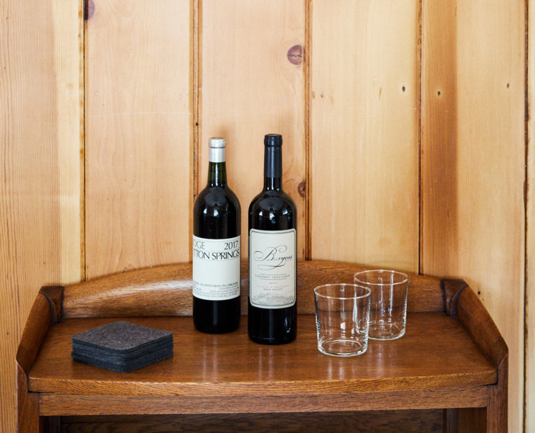 Two bottles of wine displayed on a wood table