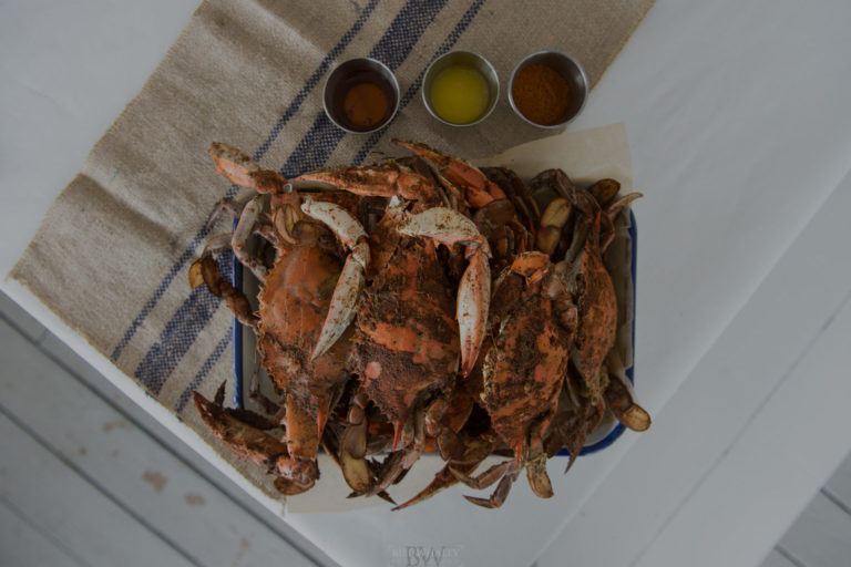 Plate of steamed seasoned crabs with dipping sauce