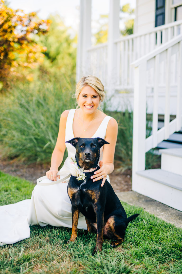 Bride sitting with dog smiling
