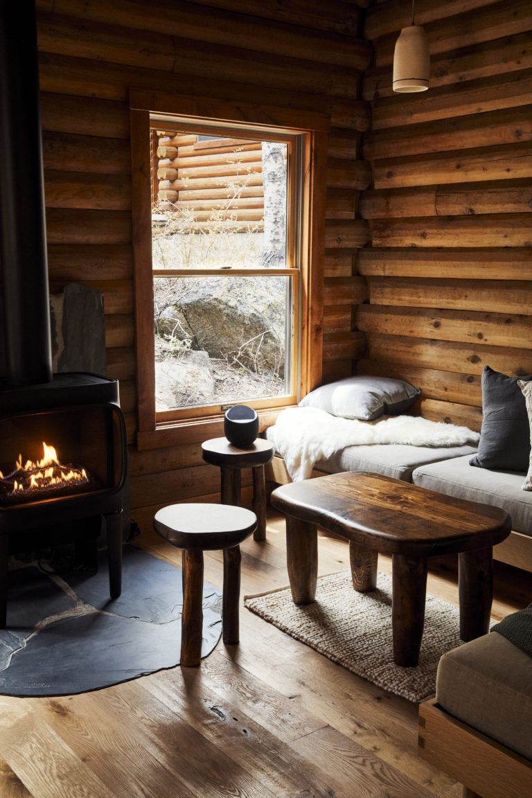 Living room in cabin with wood burning fire place