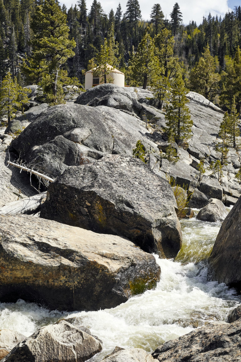 Yurt on top of a rock hill with water stream
