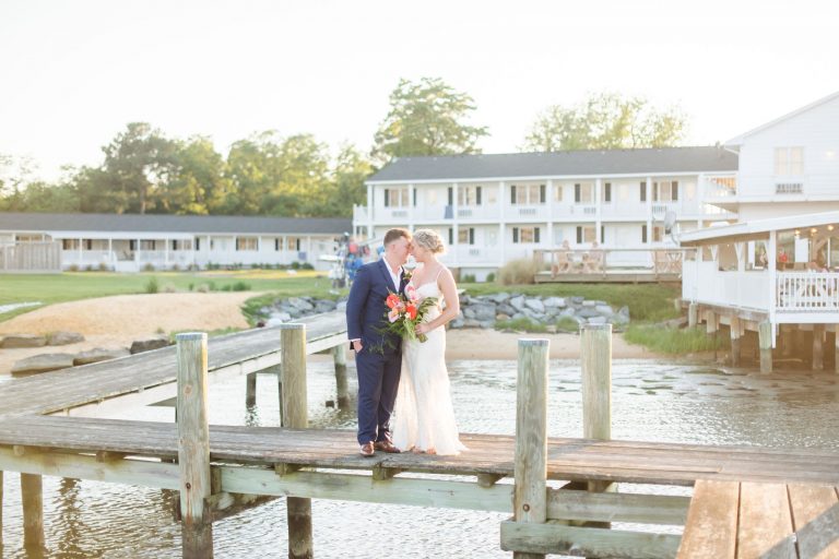 bride and groom posing on the dock