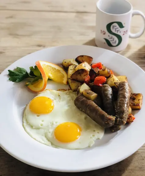 breakfast plate with eggs and sausage
